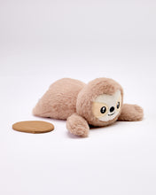 Plush sloth toy on a white background