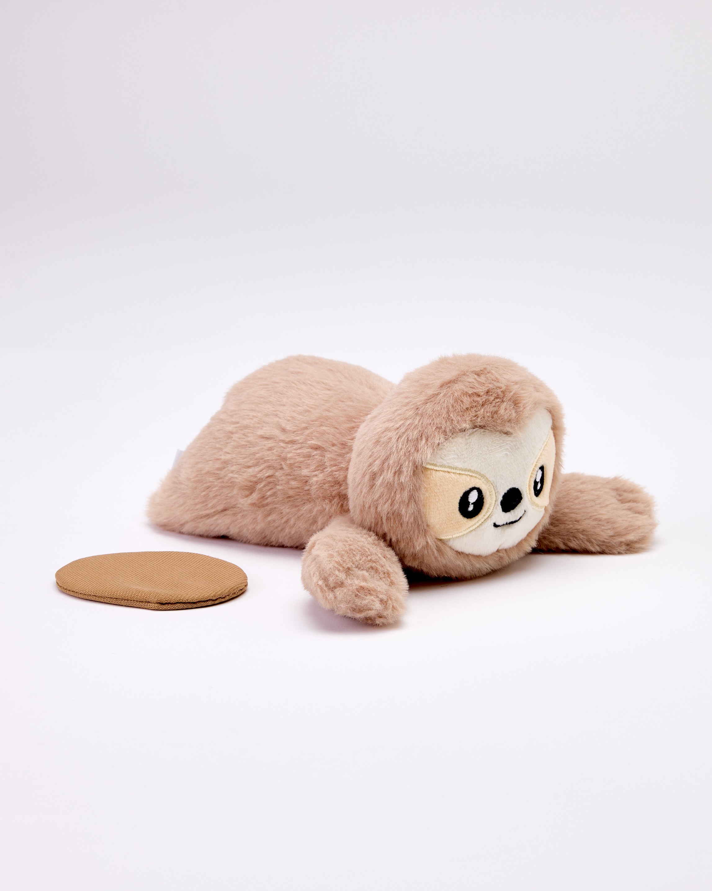 Plush sloth toy on a white background