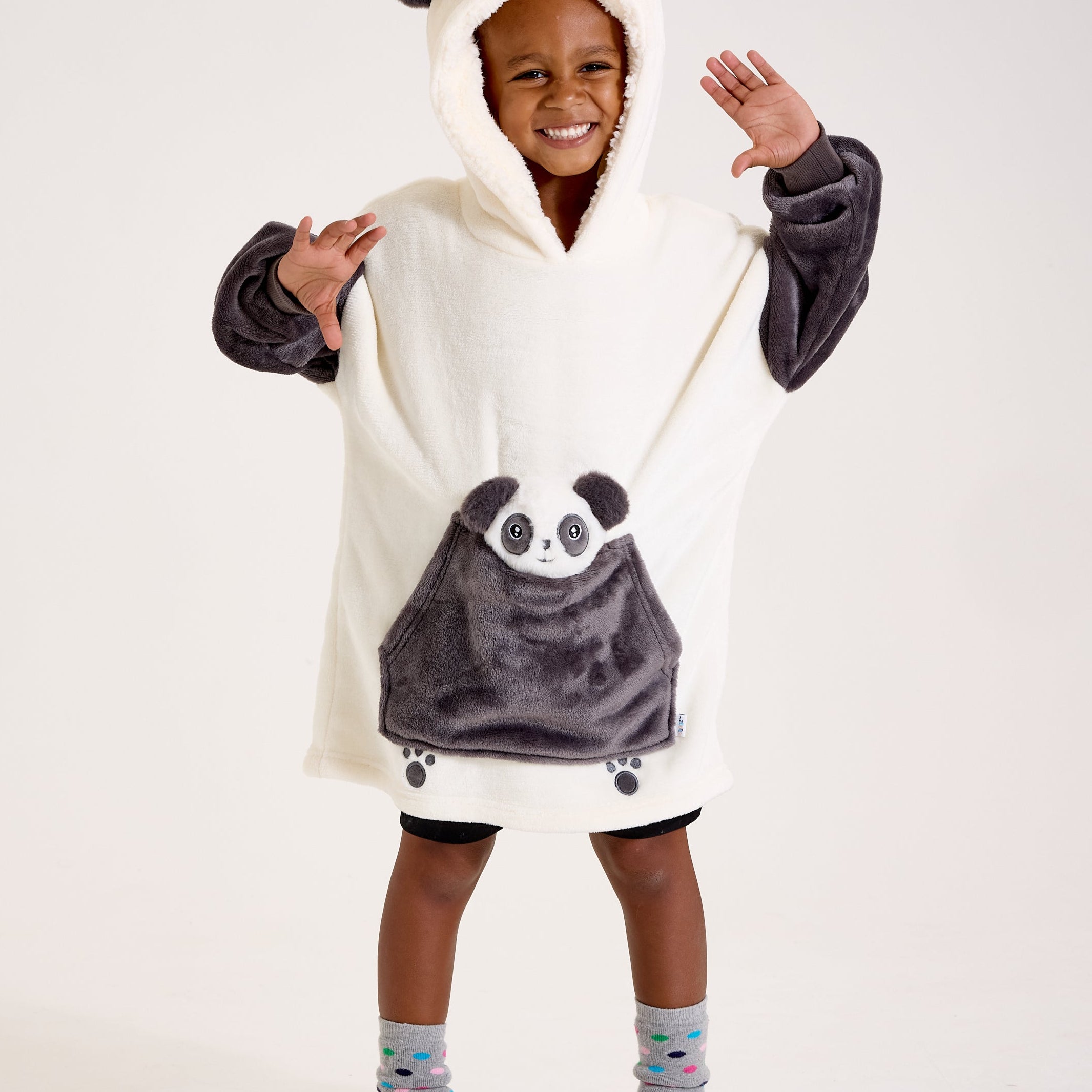 Child wearing a panda-themed poncho with a hood on a white background