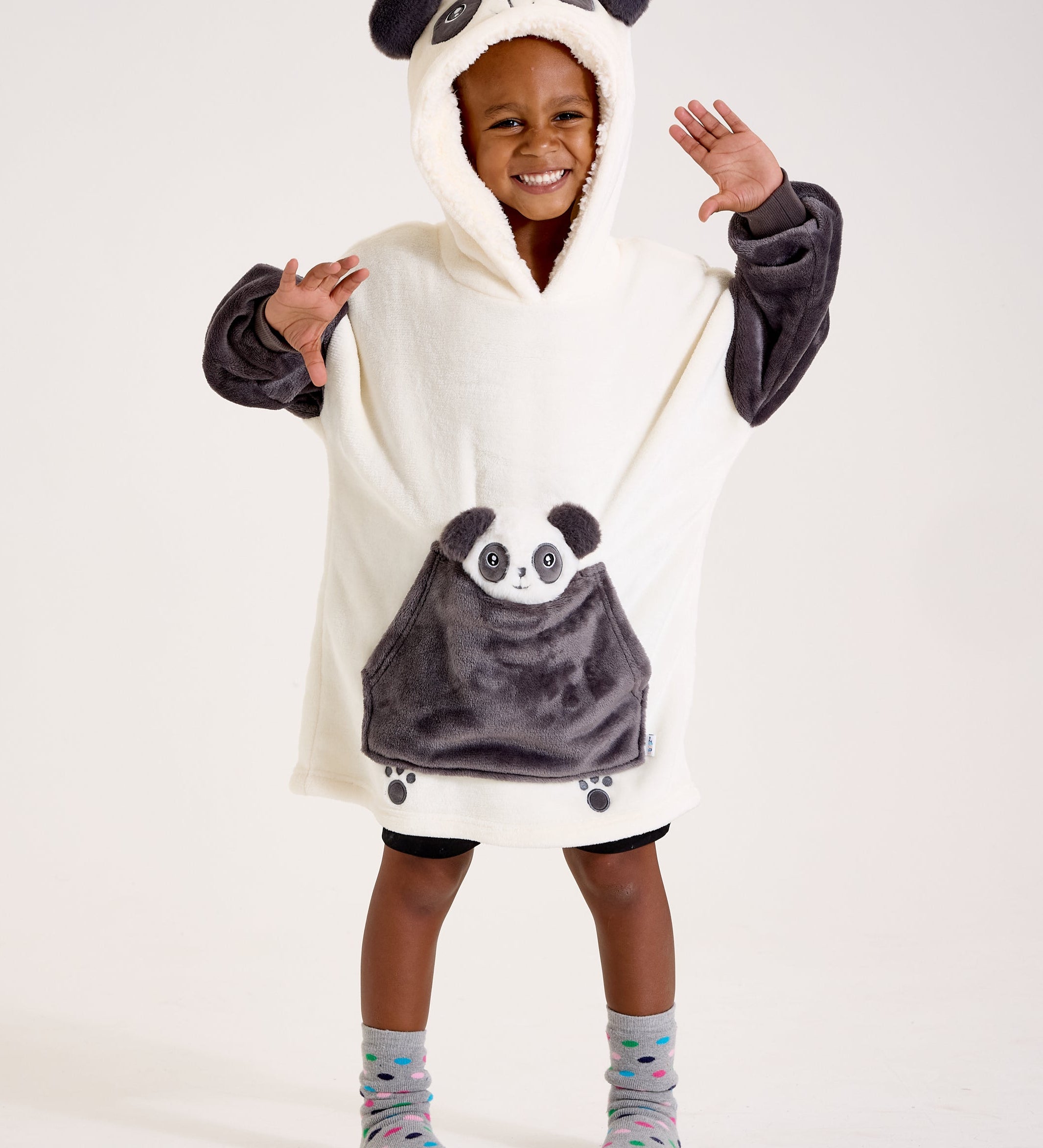 Child wearing a panda-themed poncho with a hood on a white background