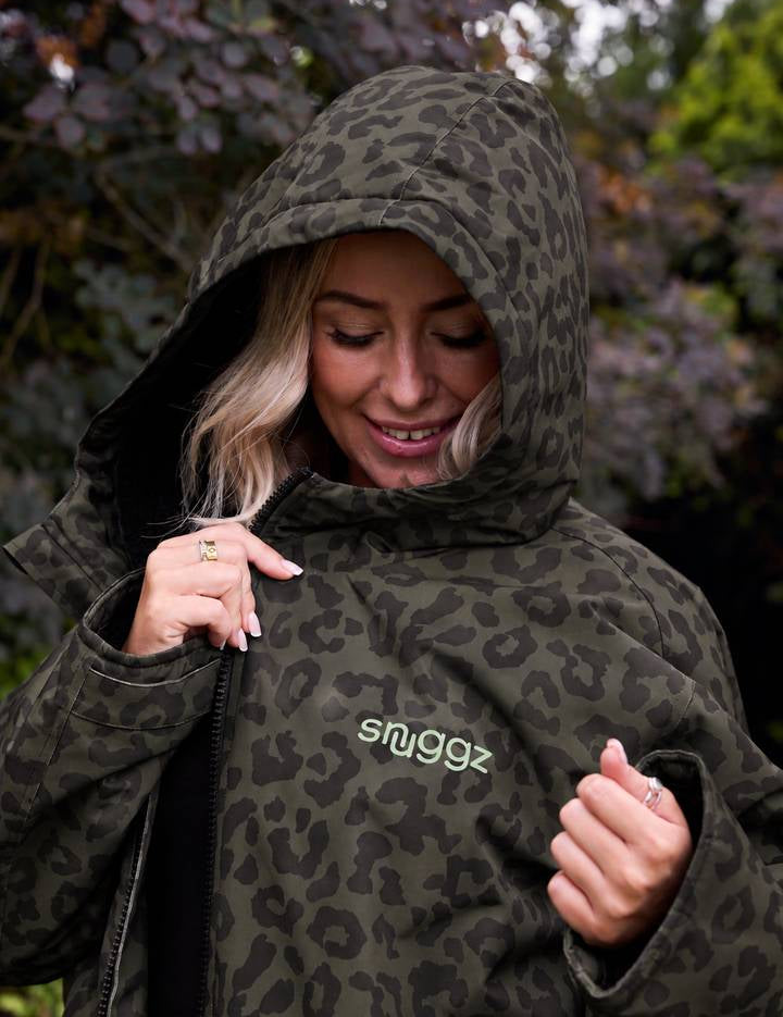 Smiling woman with the hood up on the Snuggz khaki leopard print changing robe